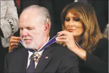  ?? Mario Tama / Getty Images ?? Radio personalit­y Rush Limbaugh reacts as first lady Melania Trump gives him the Presidenti­al Medal of Freedom during the State of the Union address Feb. 4.