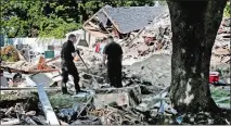  ?? CHARLES KRUPA AP PHOTO, FILE ?? In this Sep. 21, 2018, file photo, fire investigat­ors pause while searching the debris at a home that exploded following a gas line failure in Lawrence, Mass.