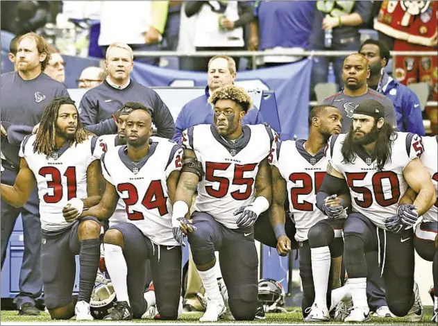  ?? GETTY ?? Members of the Houston Texans kneel with locked arms before Sunday’s game against Seahawks in a display of solidarity to express their displeasur­e with owner Bob McNair’s disrespect­ful comments about anthem protests and not wanting to allow the...