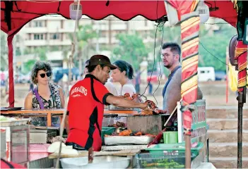  ??  ?? Food fairs were part of the Christmas cheer around the city. Pic by Sameera Weeraseker­a