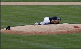  ?? ADAM HUNGER — THE ASSOCIATED PRESS ?? Yankees pitcher Masahiro Tanaka lies on the field after being hit by a ball off the bat of Giancarlo Stanton during a workout at Yankee Stadium on Saturday.