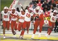  ?? Will Newton / Associated Press ?? Nebraska safety Marquel Dismuke (19) celebrates with teammates after recovering a fumble from Maryland running back Javon Leake (20) during the first half of an NCAA football game against Maryland, in College Park, Md., on Nov. 23. Nebraska’s 24-sport program has about 600 athletes and is one of a handful that makes money. Though a 10% budget cut was announced recently, the program is able to absorb the cost of coronaviru­s testing, in part because of its affiliatio­n with the university’s medical school.