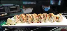  ??  ?? Shogun Palace’s Bakersfiel­d roll features crab meat, cucumber and avocado inside, topped with spicy tuna, salmon, dynamite sauce and spicy mayo.