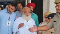  ?? (Reuters) ?? ASARAM BAPU (in white shirt) is shown after his arrest in September 2013, in Jodhpur, India.