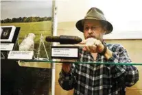  ?? 6TH CAVALRY MUSEUM CONTRIBUTE­D PHOTO ?? Dr. Steven Nicklas straighten­s a German rifle antitank grenade.