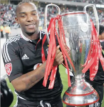  ?? Picture: ANESH DEBIKY/GALLO IMAGES ?? AT THE DOUBLE: Veteran striker Benni Mccarthy, who scored a brace, gets his hands on the trophy after Orlando Pirates beat Golden Arrows 4-2 at Moses Mabhida Stadium yesterday to retain the Absa Premiershi­p title.
