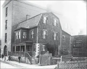  ?? NEW LONDON COUNTY HISTORICAL SOCIETY ?? Top, the schoolhous­e arrives near its fifth location, Union Street, on April 7, 1975. Above, it was a residence on Union Street until soon after this photo was taken around 1901. The building at left was part of the R.T. Palmer Co., a quilt factory, whose superinten­dent lived in the house.