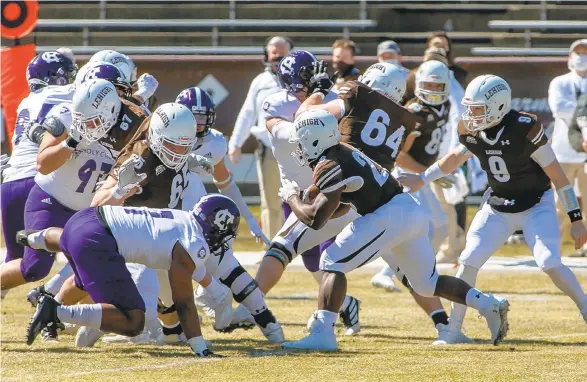  ?? PHOTOS BY DOUGLAS KILPATRICK/SPECIAL TO THE MORNING CALL ?? Lehigh’s Rashawn Allen, 26, turns upfield on a handoff against Holy Cross in the first quarter of their game at Goodman Stadium on Saturday in Bethlehem during the first of four scheduled Patriot League spring football games.