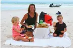  ??  ?? First class dining on the beach for the author and her children