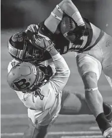  ?? ?? Brandeis’ Deron Hall brings down Reagan’s Luke Sasser during their matchup Friday at Comalander Stadium.