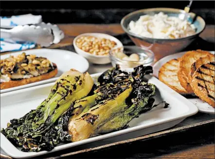  ?? ABEL URIBE/CHICAGO TRIBUNE PHOTOS; SHANNON KINSELLA/FOOD STYLING ?? Try grilling escarole and heaping it over ricotta and thick slabs of sourdough bread, with grill marks the envy of any steakhouse rib-eye.