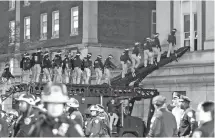  ?? EPA-Yonhap ?? New York City police officers use a ramp on an armored vehicle to enter Hamilton Hall at Columbia University after pro-Palestinia­n protesters barricaded themselves in the building earlier in the day in New York, Tuesday.