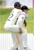  ??  ?? Jofra Archer gets a lift from team-mate Rory Burns in Whangarei.