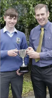  ??  ?? Sam Ireland, third year Sportspers­on of the Year, receives his award from Bill Maher.