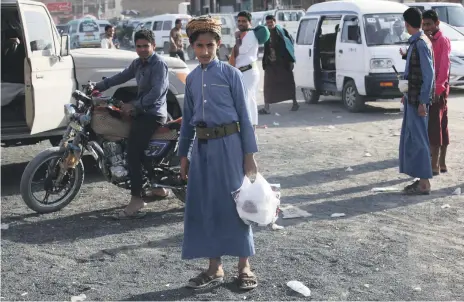  ?? AP ?? A young Yemeni man leaves a shop in Marib, a city saved from the hunger, suffering and illness in the rest of the country