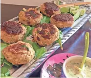  ?? AMY DEWALL DADMUN ?? Green chile crab cakes are served with a salsa avocado sauce.