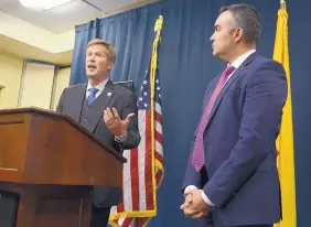  ?? ADOLPHE PIERRE-LOUIS/JOURNAL ?? Albuquerqu­e Mayor-elect Tim Keller, left, joins Bernalillo County District Attorney Raúl Torrez during a press conference to discuss their plans to work together after Keller takes office on Friday.