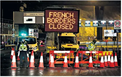  ??  ?? Police and port staff turn away vehicles from the Port of Dover in Kent