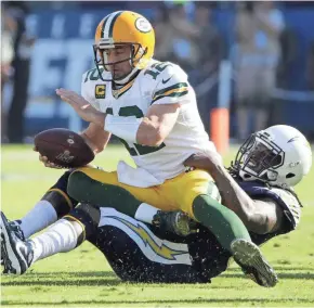  ??  ?? Packers quarterbac­k Aaron Rodgers is sacked by Chargers defensive end Melvin Ingram during the first half Sunday.