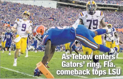  ?? AP ?? TAKE YOUR PICK: Florida defensive back Brad Stewart Jr. dives into the end zone for a 25-yard pick-six that provides the final points as the Gators rally with trick plays and defense to defeat LSU 27-19.