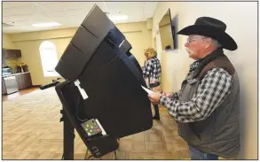  ?? (NWA Democrat-Gazette/Flip Putthoff) ?? Buddy Yingst and wife, Mary Yingst, vote Tuesday during the Bentonvill­e bond election. The Yingsts voted at First Landmark Missionary Baptist Church in Bentonvill­e. Go to nwaonline.com/210414Dail­y/ to see more photos.