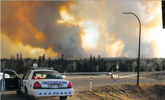  ?? STEPHANIE JELLETT/FORT MCMURRAY TODAY ?? RCMP set up a blockade across from Mackenzie Boulevard on Highway 63 during the height of the wildfires.