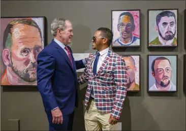  ?? PHOTOS BY LEONARD ORTIZ — STAFF PHOTOGRAPH­ER ?? Former President George W. Bush speaks with veteran Daniel Casara next to the painting of Casara, top center, during a tour of Bush's paintings for the exhibit, “Portraits of Courage: A Commander in Chief's Tribute to America's Warriors.”