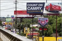  ?? AMERICAN-STATESMAN 2014 ?? Reagan National Advertisin­g billboards dwarf signs on I-35’s upper deck. Reagan, which challenged the city’s fee, owns about 80 percent of the billboards in Austin, court filings show.