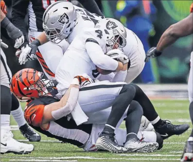  ?? [GARY LANDERS/THE ASSOCIATED PRESS] ?? The Bengals’ Sam Hubbard hauls down Raiders quarterbac­k Derek Carr for one of his two sacks in a game in which he also played at fullback and on special teams.