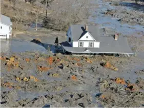  ?? J. MILES CARY/NEWS SENTINEL ?? In 2008, a home is surrounded by 1.1 billion gallons of toxic coal ash slurry that escaped a failed dike at the TVA Kingston Fossil Plant in Roane County.