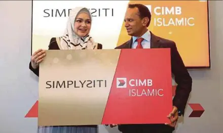  ?? PIC BY HALIMATON SAADIAH SULAIMAN ?? Simply SS Trading president and founder Datuk Seri Siti Nurhaliza Tarudin (left) and CIMB Islamic Bank Bhd chief executive officer Rafe Haneef after the signing of a collaborat­ion agreement in Kuala Lumpur yesterday.