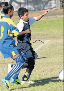  ?? Picture: BRIAN WITBOOI ?? STRONG CHALLENGE: Bayview Primary’s Rodney O’Connor, right, is challenged by Helenvale Primary’s Brendiline Hendricks during their U14 soccer match. Helenvale won 2-0