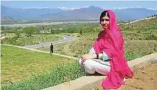  ?? AFP ?? Malala Yousafzai poses for a photograph in the precincts of the all-boys Swat Cadet College Guli Bagh during her visit to her hometown yesterday.