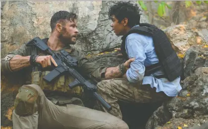  ?? NETFLIX ?? Chris Hemsworth, left, and Rudhraksh Jaiswal star in the painful Extraction, a film that opts for razzle-dazzle over reason.