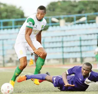  ??  ?? Stanley Okorom of MFM tumbles under pressure from Anayo Ogbonna of Plateau United during a league match last season