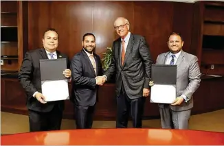  ?? GWINNETT CHAMBER ?? Santiago Marquez (from left), president and CEO of the Georgia Hispanic Chamber of Commerce, chairman-elect Antonio Molina, Gwinnett Chamber board chairman Tom Andersen and Nick Masino, president and CEO, seal the alliance of the two business groups with a handshake.