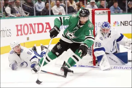  ?? (AP) ?? Dallas Stars center Andrew Cogliano (center), is brought down as Tampa Bay Lightning center Tyler Johnson (left), picks up the tripping penalty during
the first period of an NHL hockey game in Dallas, on Jan 27.