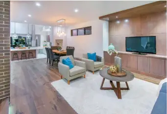  ??  ?? A handsome arrangemen­t of flat panel, oak millwork contains storage and home electronic­s in the great room with consistent, smooth style.