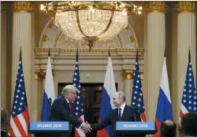  ?? ALEXANDER ZEMLIANICH­ENKO — THE ASSOCIATED PRESS ?? U.S. President Donald Trump shakes hand with Russian President Vladimir Putin after their meeting Monday at the Presidenti­al Palace in Helsinki, Finland.