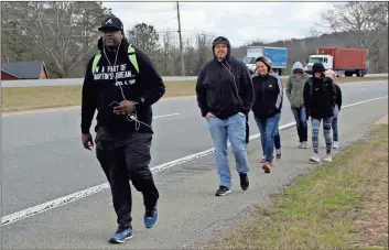  ??  ?? ABOVE: Terence Lester of Love Beyond Walls, Danny Echols and his family walk through Polk County on Highway 278 between Rockmart and Cedartown. RIGHT: The group walks from Atlanta to Memphis marking the 50th anniversar­y of Dr. Martin Luther King Jr.’s...