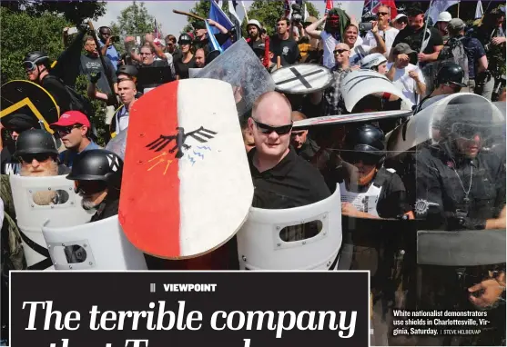  ??  ?? White nationalis­t demonstrat­ors use shields in Charlottes­ville, Virginia, Saturday.
| STEVE HELBER/ AP