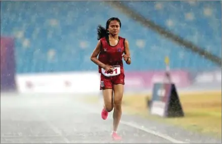  ?? AFP ?? Bou Samnang lost the race, but won the heart of the public for her indomitabl­e spirit in the women’s 5km final during the 32nd SEA Games in Phnom Penh in May 2023.