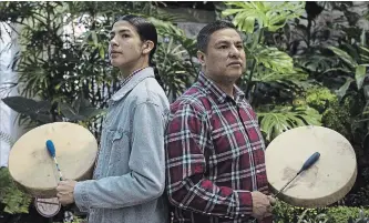  ?? KAYLE NEIS THE CANADIAN PRESS ?? Jarron Gadwa, left, and Jacob Faithful are part of Young Spirit Singers. The group’s album “Mewasinsat­ional — Cree Round Dance Songs” is contending in the best regional roots category at the Grammys.