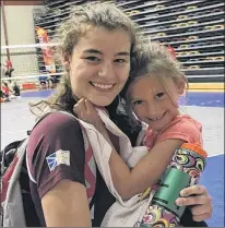  ?? CANADA GAMES PHOTO ?? Newfoundla­nd and Labrador volleyball player Emma Hackett gets a hug from her namesake, eight-year-old Emma Wareham, the daughter of Newfoundla­nd and Labrador head coach Nathan Wareham, after a match against Ontario Tuesday at the 207 Canada Summer...