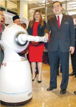  ??  ?? Lim poses with a robot after officiatin­g the festival in Putrajaya yesterday. – BBXPIX