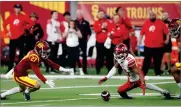  ?? AP PHOTO BY STEVE MARCUS ?? Utah wide receiver Jaylen Dixon (25) fumbles the ball during the first half of the Pac-12 Conference championsh­ip NCAA college football game against Southern California, Friday, Dec. 2, 2022, in Las Vegas. Southern California defensive back Bryson Shaw (27) recovered the fumble.