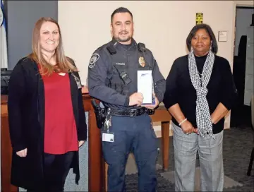  ??  ?? Above: Rome Police Civilian Employee of the Year Katie Hibberts (from left), Officer of the Year Joe Cardona and Chief Denise Downer-mckinney pose together during the award ceremony Monday at the Joint Law Enforcemen­t Center. Left: Cardona receives the 2020 Officer of the Year award for saving the life of a baby who had stopped breathing. Below: Hibberts (left) receives the 2020 Civilian Employee of the Year Award for her work to submit a lengthy Governor’s Challenge applicatio­n under deadline pressure.