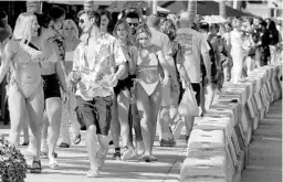  ?? MIKE STOCKER/SOUTH FLORIDA SUN SENTINEL PHOTOS ?? Afternoon partiers crowd the sidewalk Thursday as Spring Break ramps up on Fort Lauderdale beach.