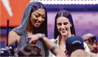  ?? Adam Hunger/Associated Press ?? Angel Reese, left, and Caitlin Clark, right, provide an injection of star power to the Chicago Sky and Indiana Fever, respective­ly, who selected them in the first round of the draft Monday.