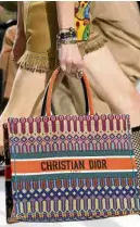  ??  ?? CHRISTIAN DIOR Tapestry handbag with leather handles